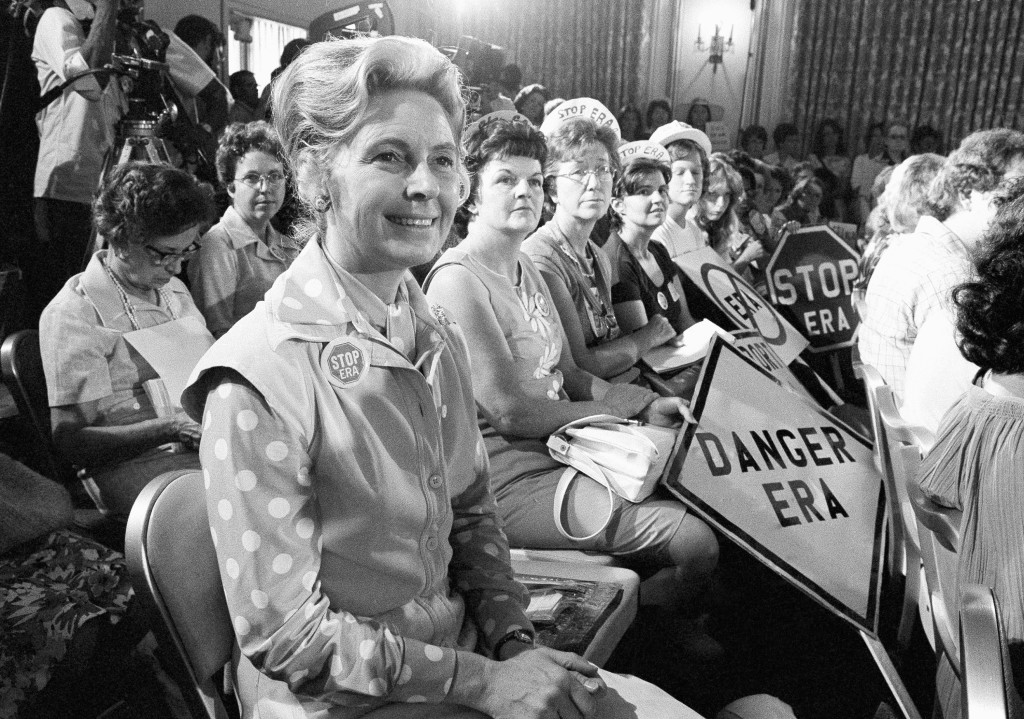 In this Aug. 10, 1976, file photo, women opposed to the Equal Rights Amendment sit with Phyllis Schlafly, left, national chairman of Stop ERA, at hearing of Republican platform subcommittee on human rights and responsibilities in a free society in Kansas City, Mo. One of the leading opponents of the ERA during the 1970s was conservative Illinois lawyer Phyllis Schlafly, who launched a campaign called Stop ERA and is credited with helping mobilize public opinion against the amendment in some of the states that balked at ratifying it. (AP Photo/File)